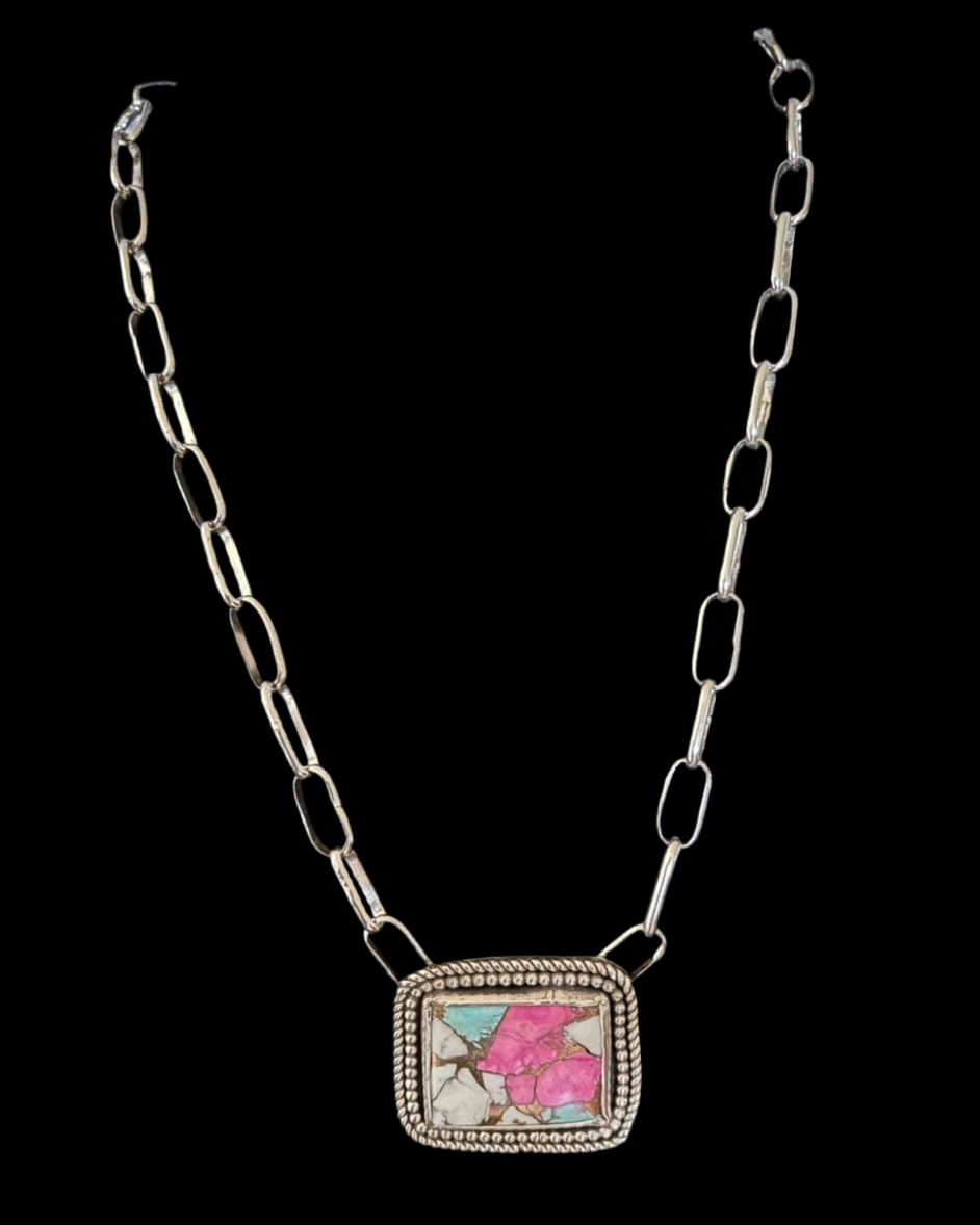 Necklace with a square pendant featuring floral designs on a black background