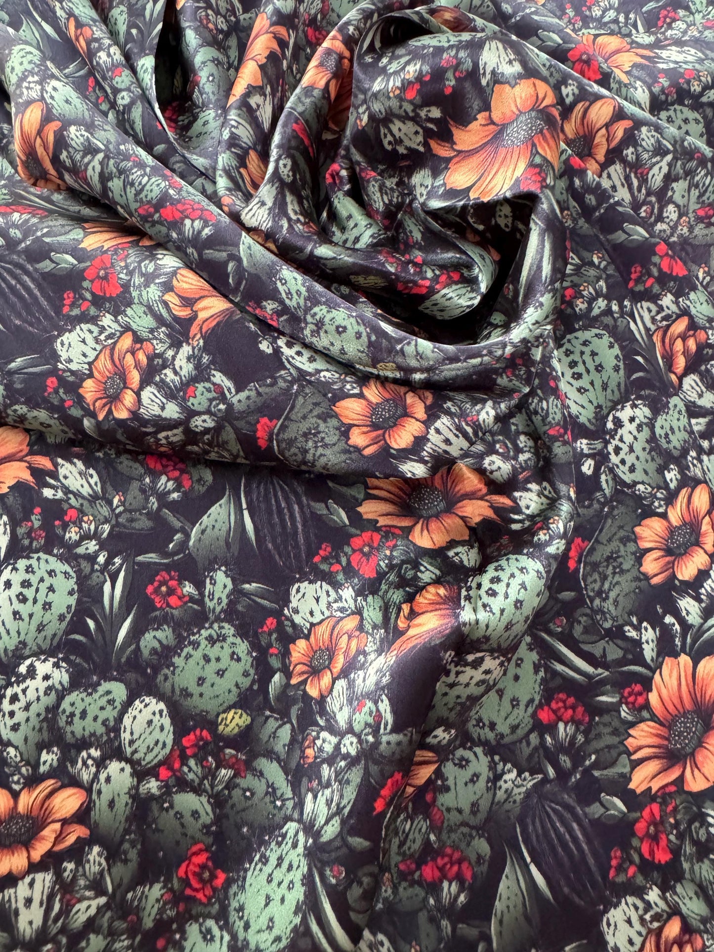 Floral and cactus patterned fabric with a dark background