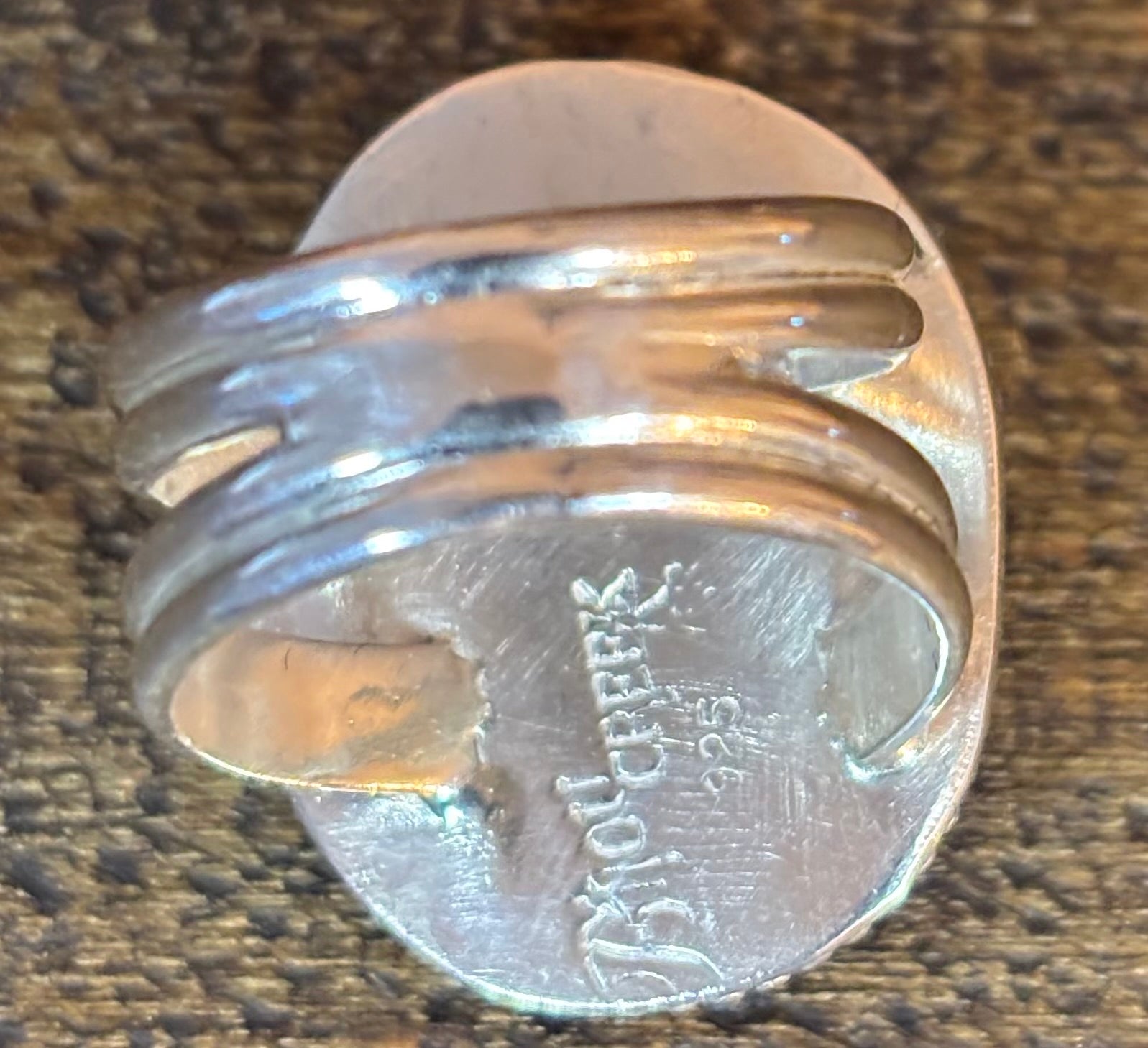 Silver ring on a quarter to show size