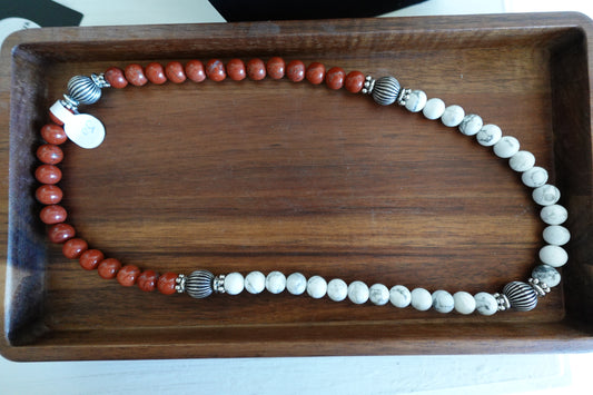 Beaded necklace on a wooden tray