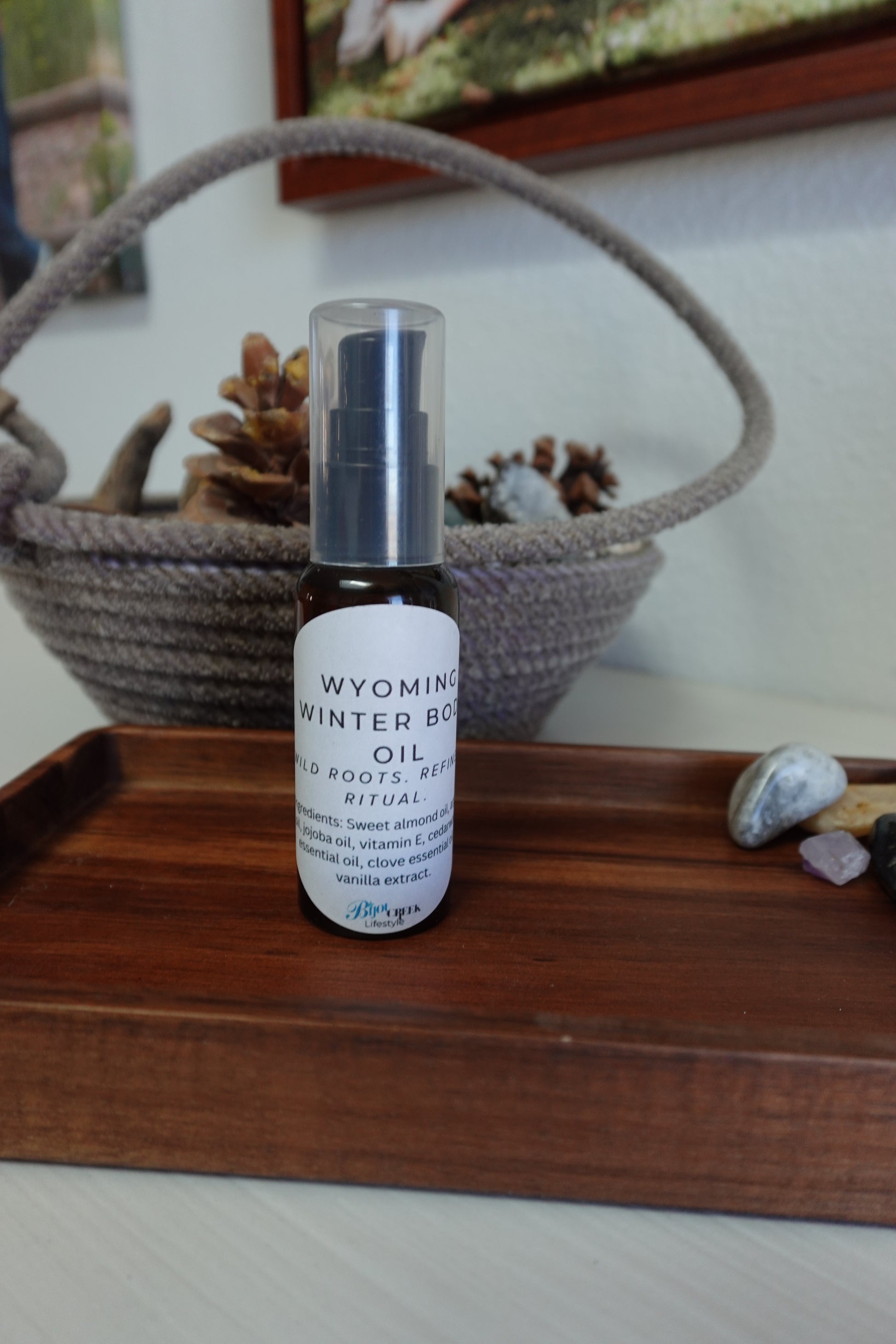 Bottle of body oil on a wooden tray