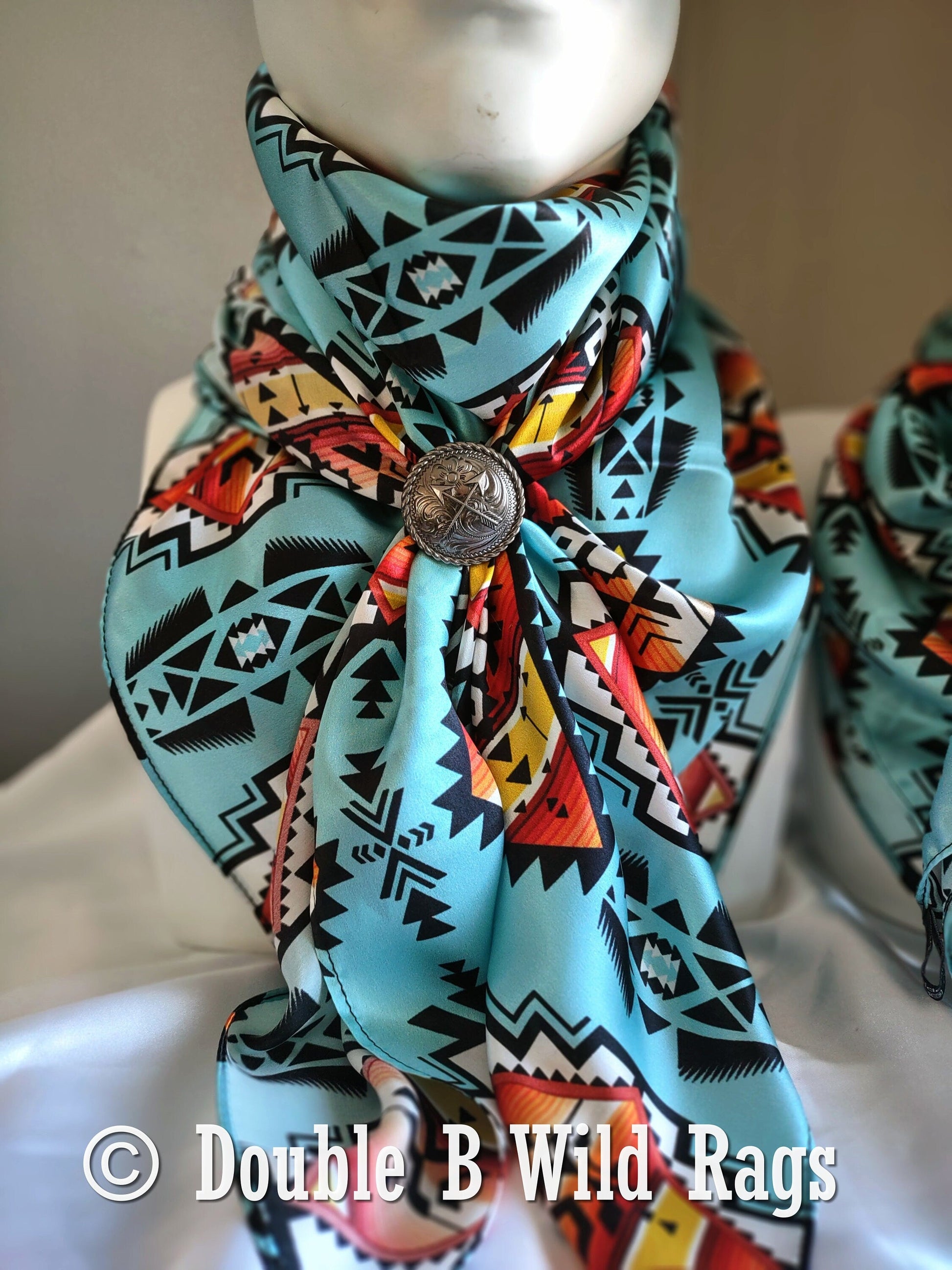 Colorful patterned scarf with a button on a mannequin, branded 'Double B Wild Rags'.