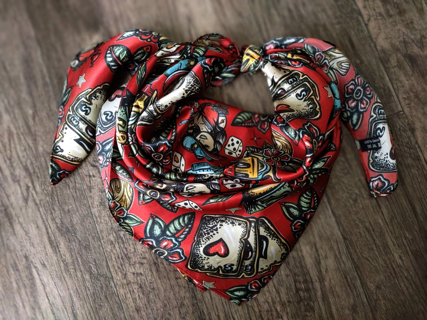 Red patterned scarf on a wooden surface