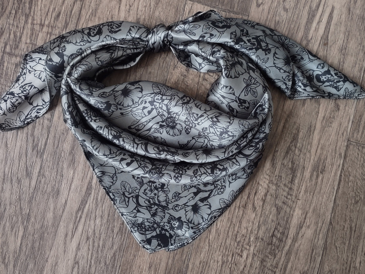 Black and white patterned scarf on a wooden surface