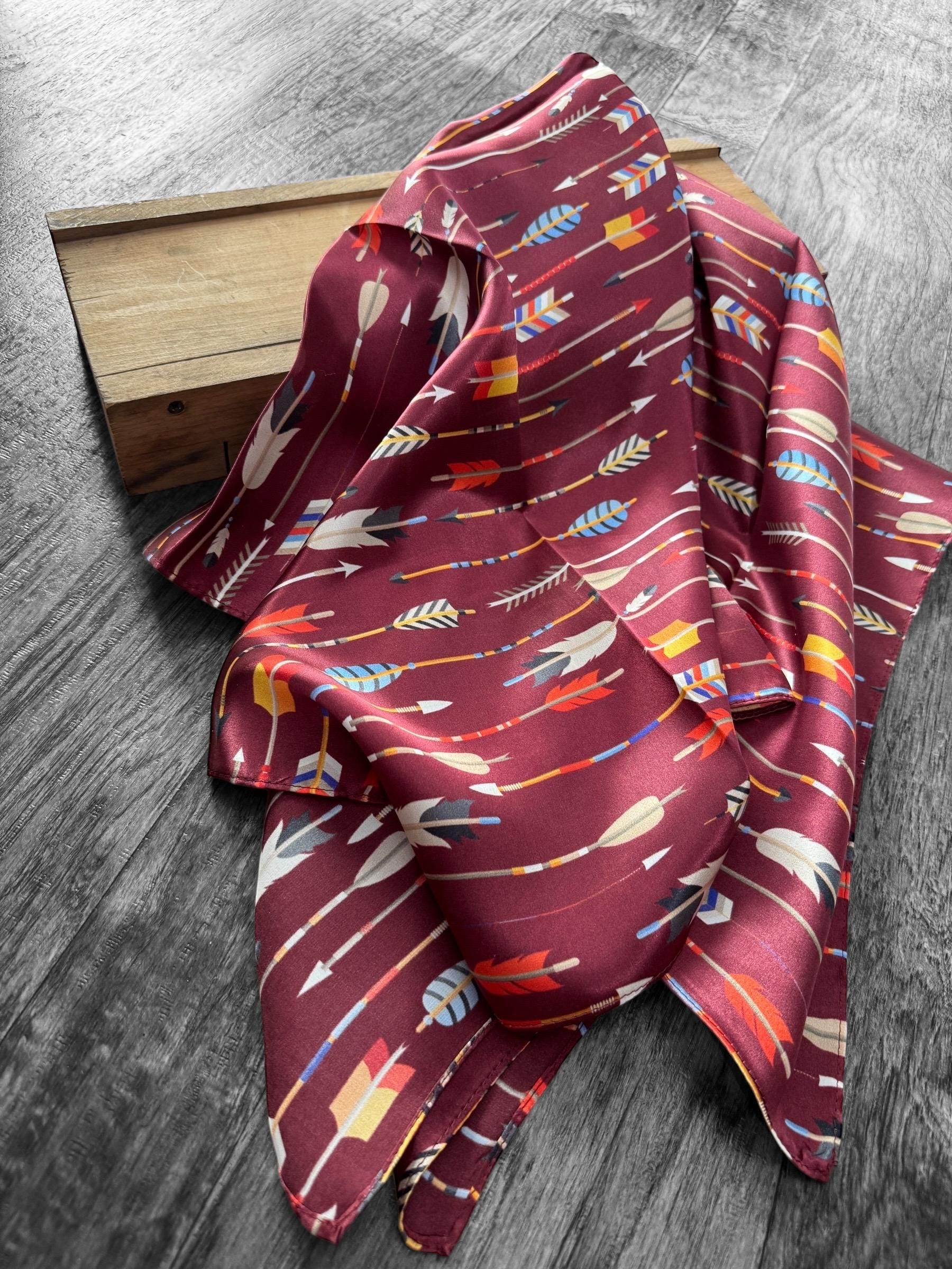 Maroon fabric with colorful arrow pattern on a wooden block