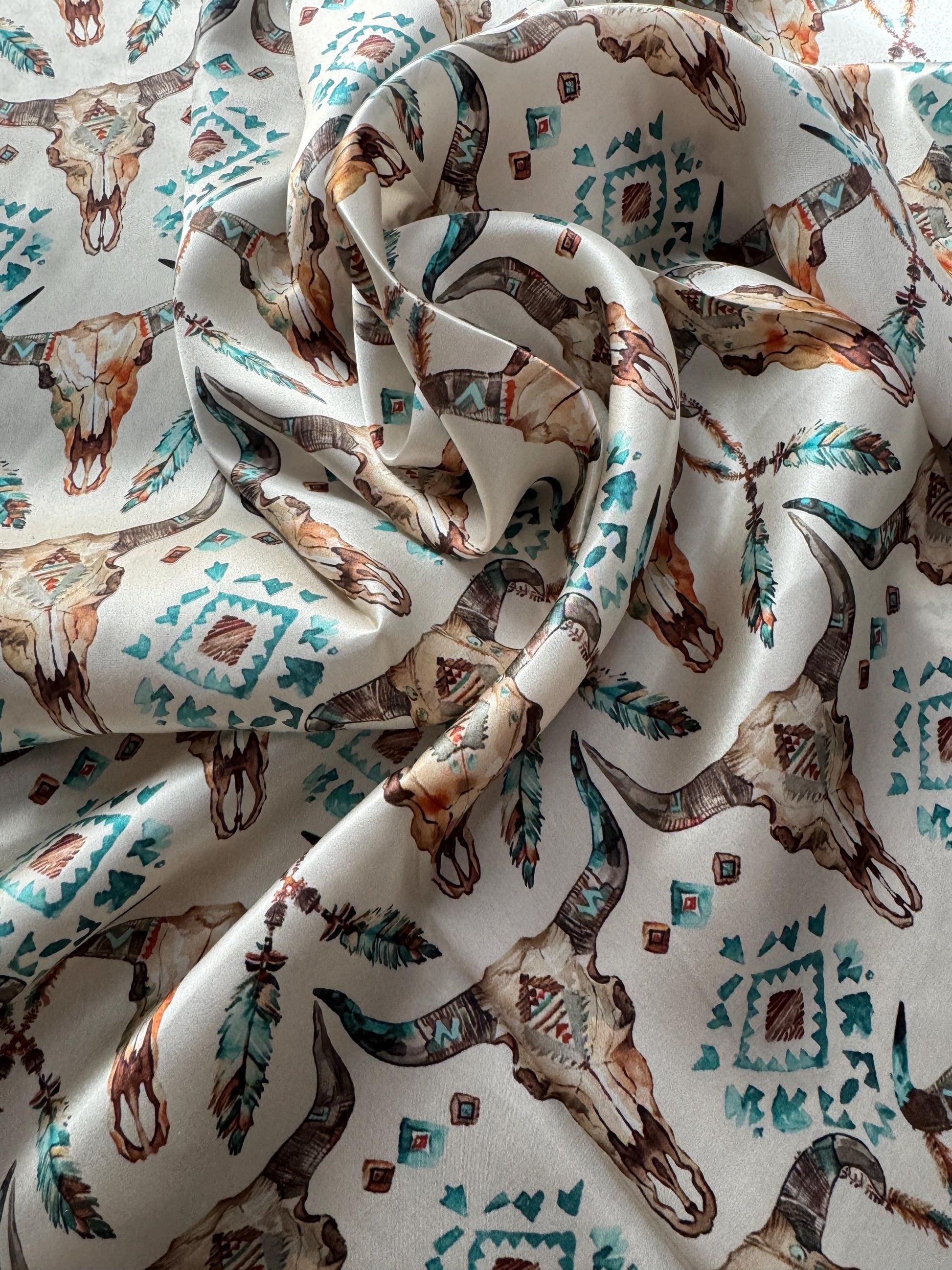 Close-up of patterned fabric with animal skulls and geometric designs.
